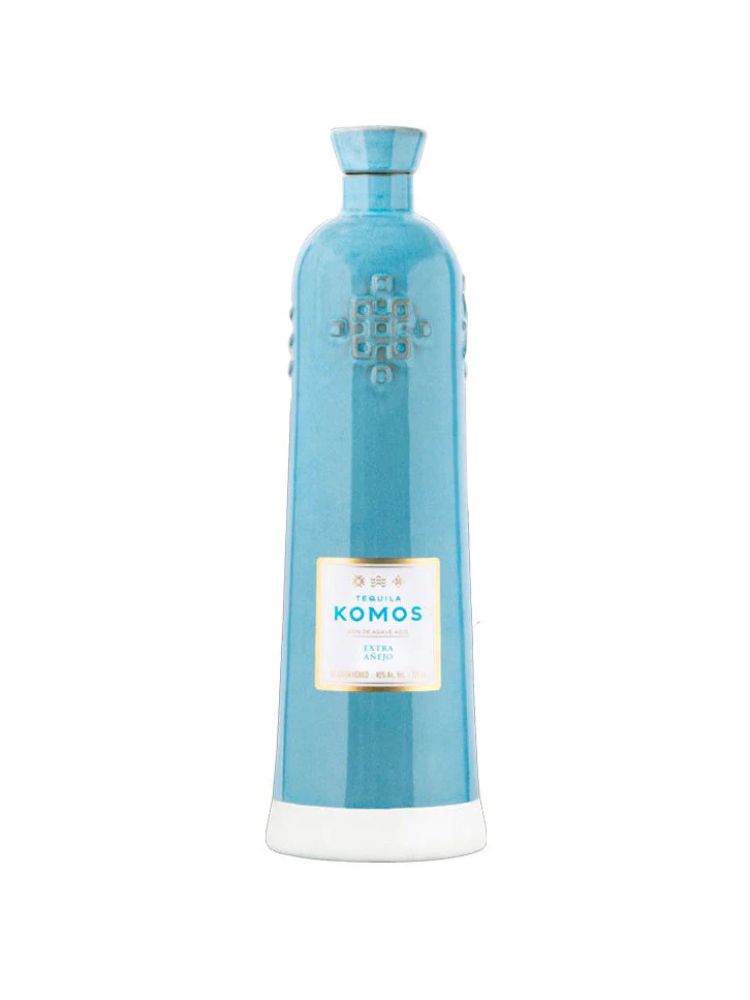 Komos Extra Añejo Tequila bottle on white background.