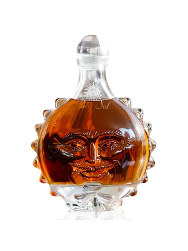 Tequila Rey Sol Extra Añejo bottle on white background.