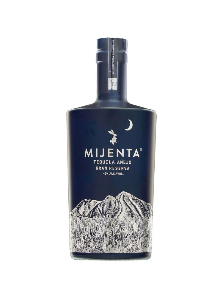 Mijenta Añejo Tequila bottle on white background.